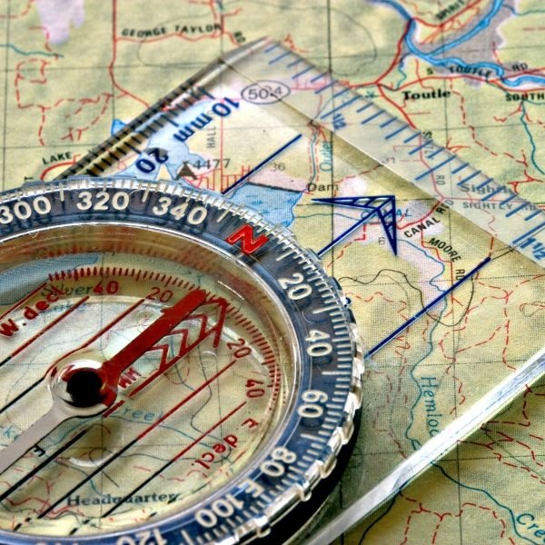 Compass pointing true north on top of a map.