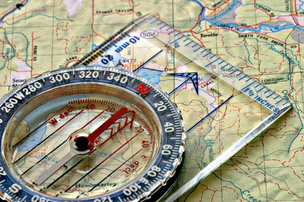 Compass pointing true north on top of a map.